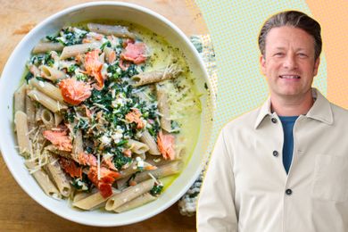Jamie Oliver next to a bowl of pasta with smoked salmon and greens
