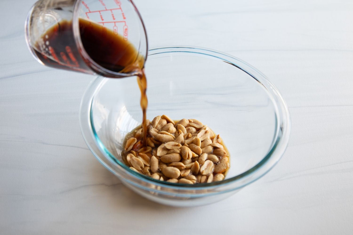 Pouring porter over peanuts to make Dixieland Peanut Pie with Porter.