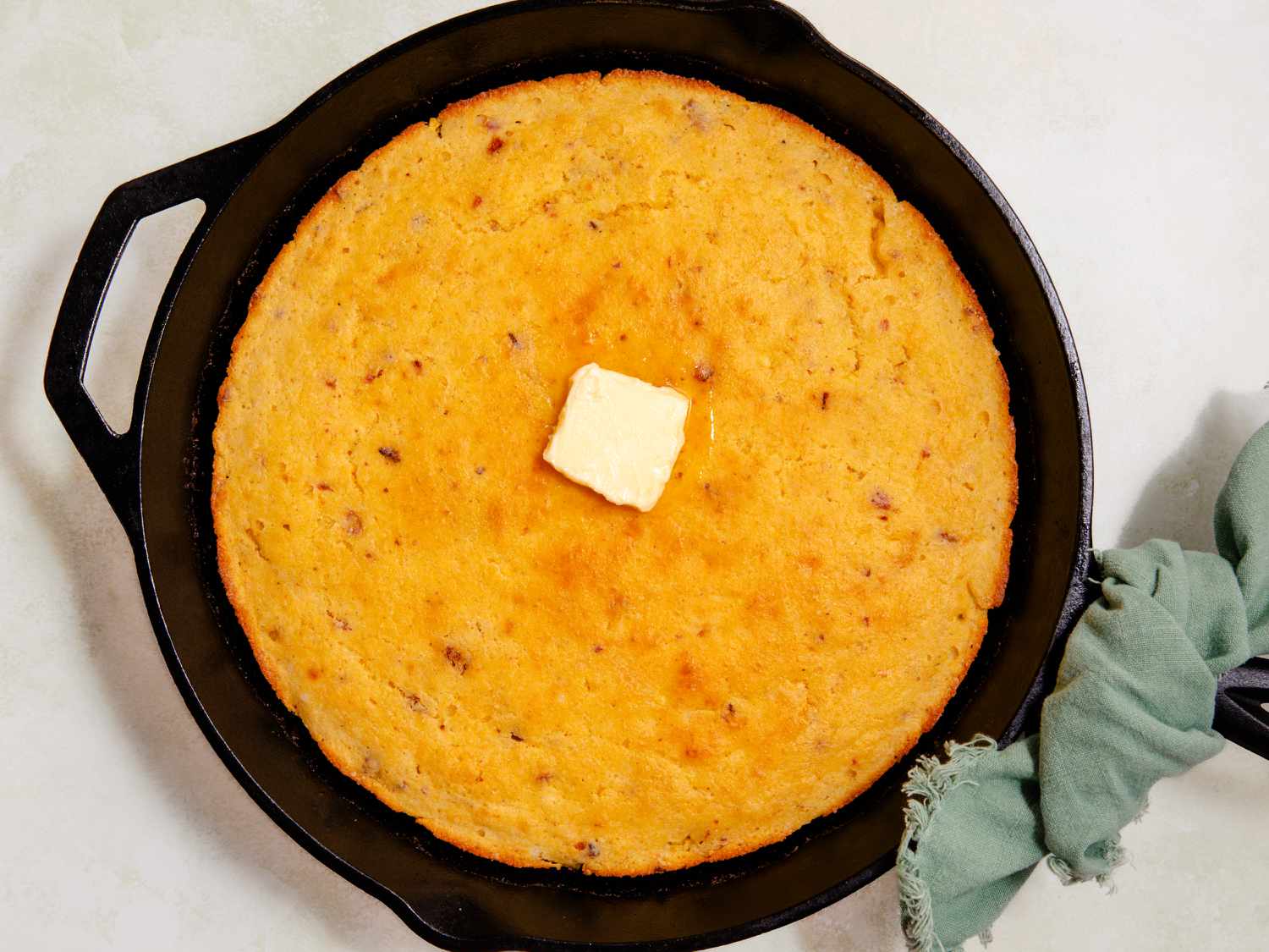 A cast iron skillet with cornbread inside
