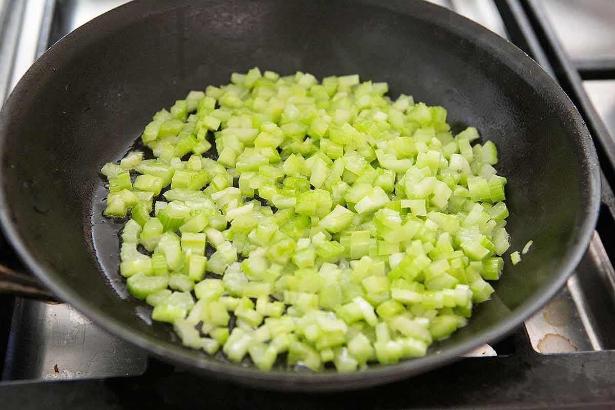 Braising chopped celery in a pan