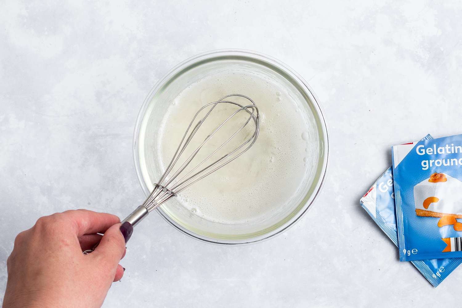 A glass bowl with gelatin to make the no bake cheesecake filling.