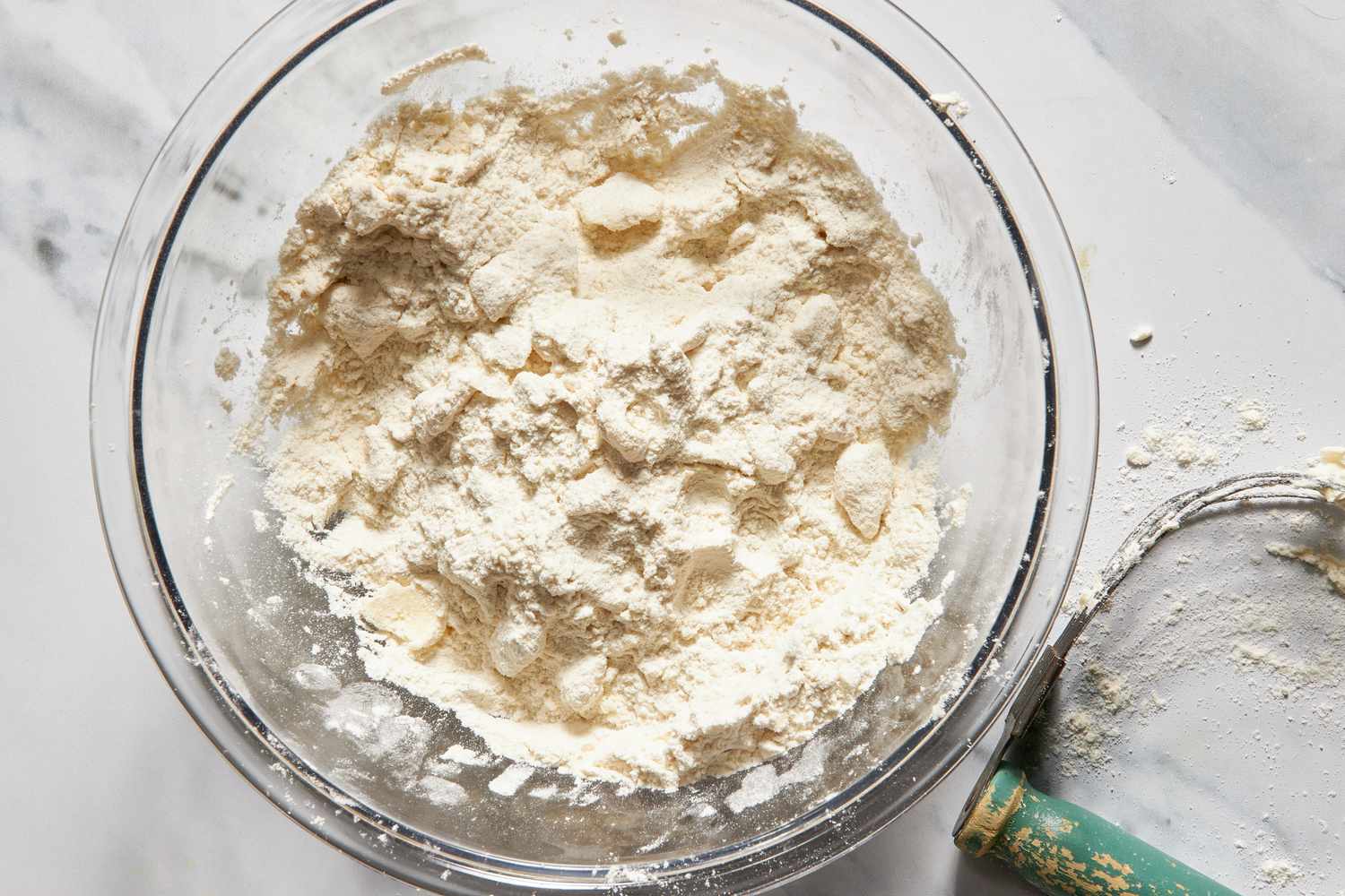 Pea-sized butter pieces in the bowl of flour for for chicken cobbler with cheddar bay biscuit top recipe