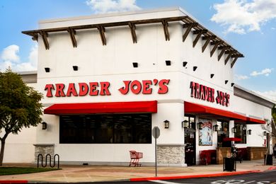 Exterior of a Trader Joes store with the logo prominently displayed on the building