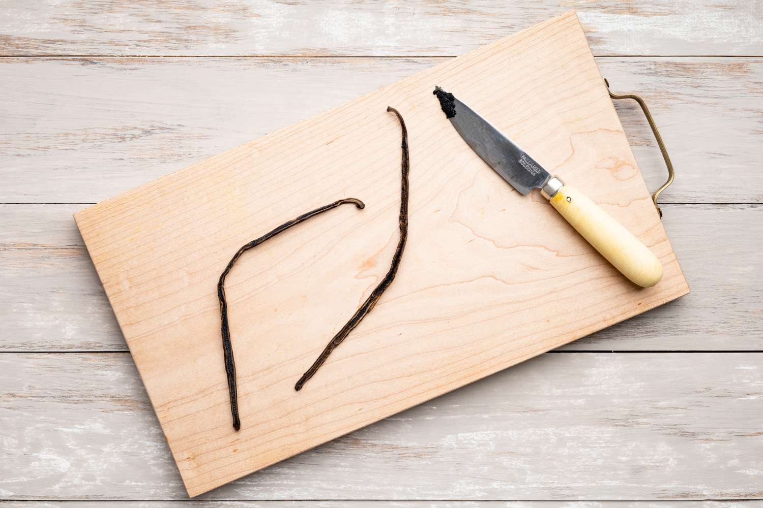 Split and Scrapped Vanilla Bean on Cutting Board for Crème Recipe