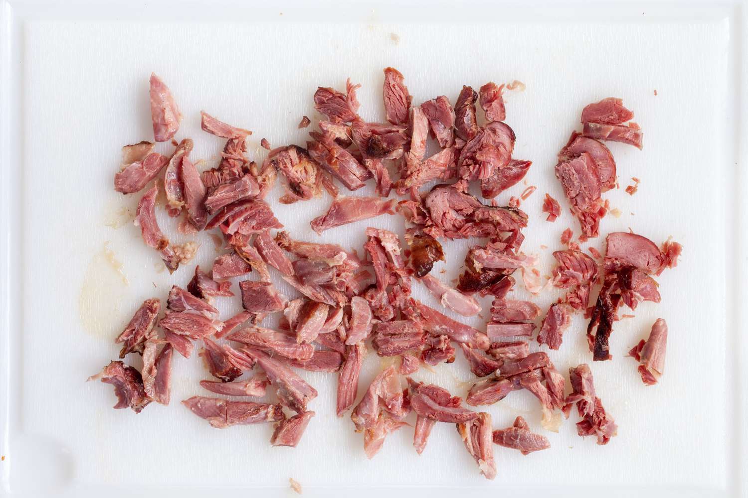 Chopped ham on a cutting board for a southern collard greens recipe.