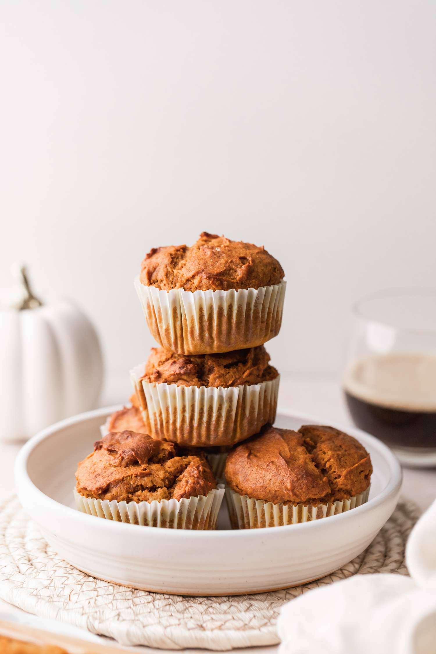 Quick and easy pumpkin muffins stacked in a serving bowl.