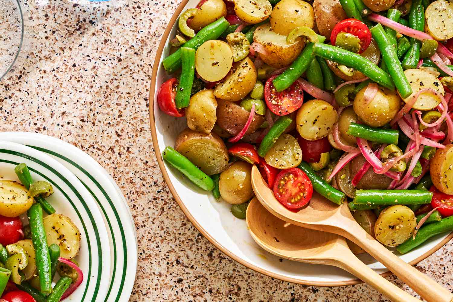Bowl of potato salad with green beans and tomatoes
