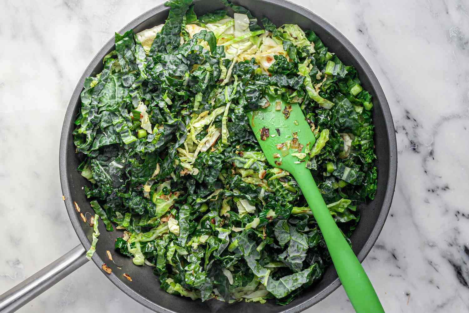 Cabbage and Kale on Skillet with a Spatula for Bubble and Squeak Recipe