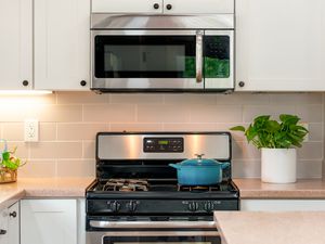 A kitchen stove and built in microwave above it