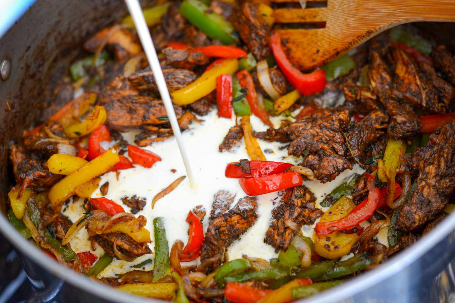 Heavy Cream Added to Jerk Chicken and Vegetables for Jerk Chicken Rasta Pasta