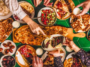 family enjoying middle eastern food (dolma, kebabs, flatbread) for iftart, Ramadan