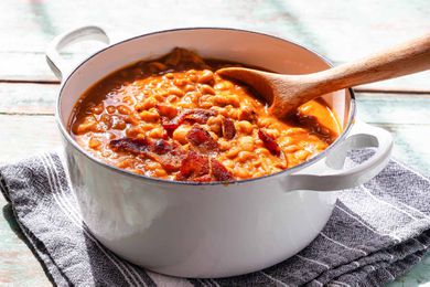 Baked Beans with Molasses - baked beans in a pot with a wooden spoon