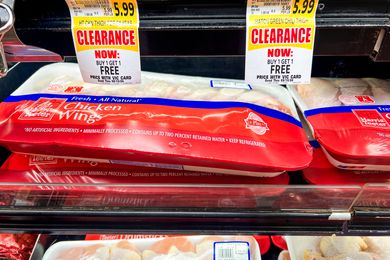 Chicken wings in a grocery store with clearance signs