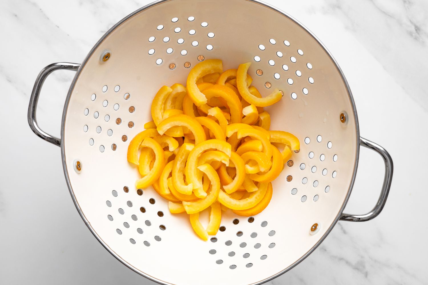 Boiled Orange Peels in a Colander for Chocolate Covered Orange Peels Recipe