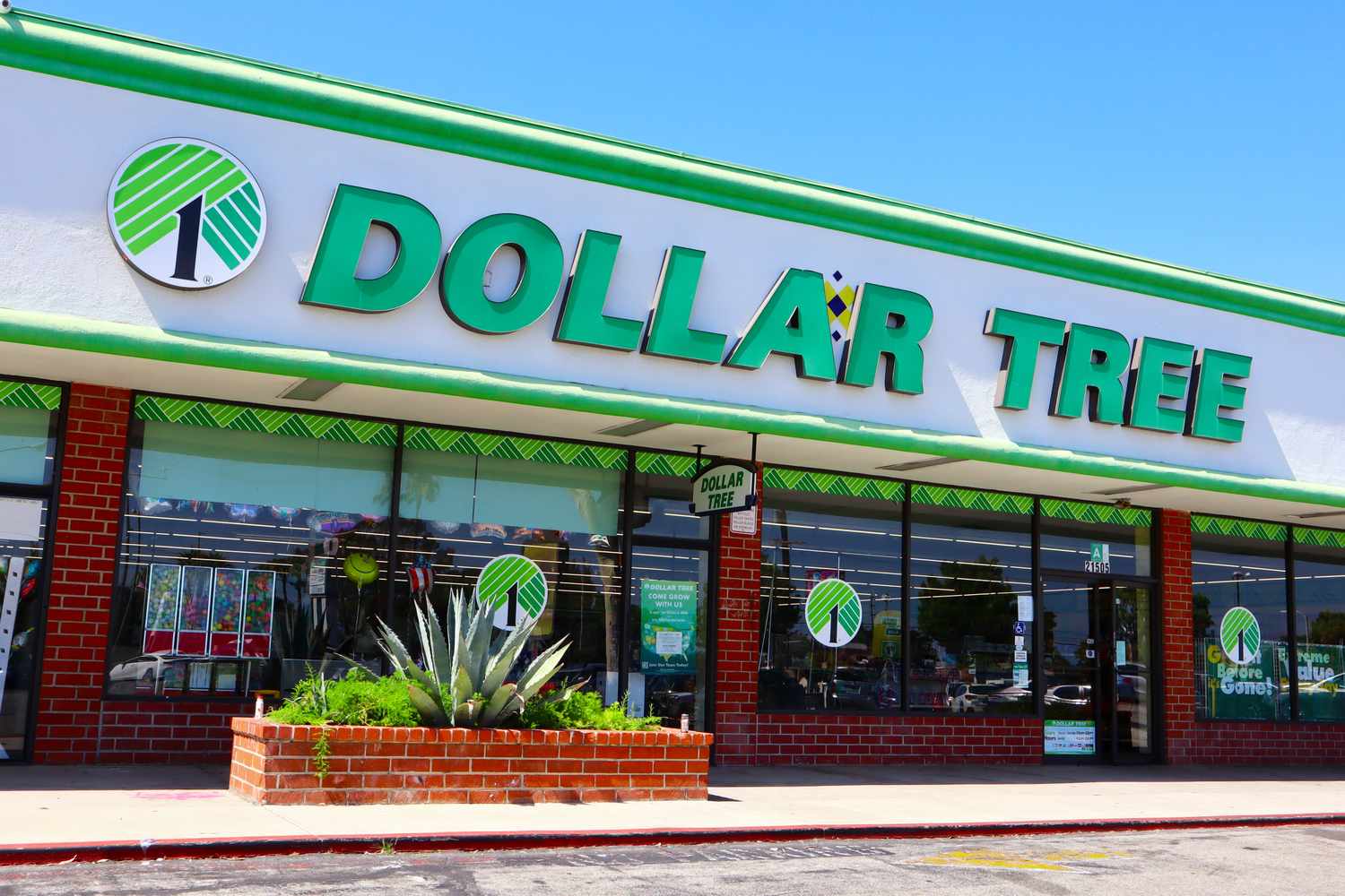 A Dollar Tree storefront, brick and white facade with green logo