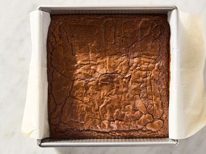 Freshly baked pan of brownies on a parchmentlined square baking dish