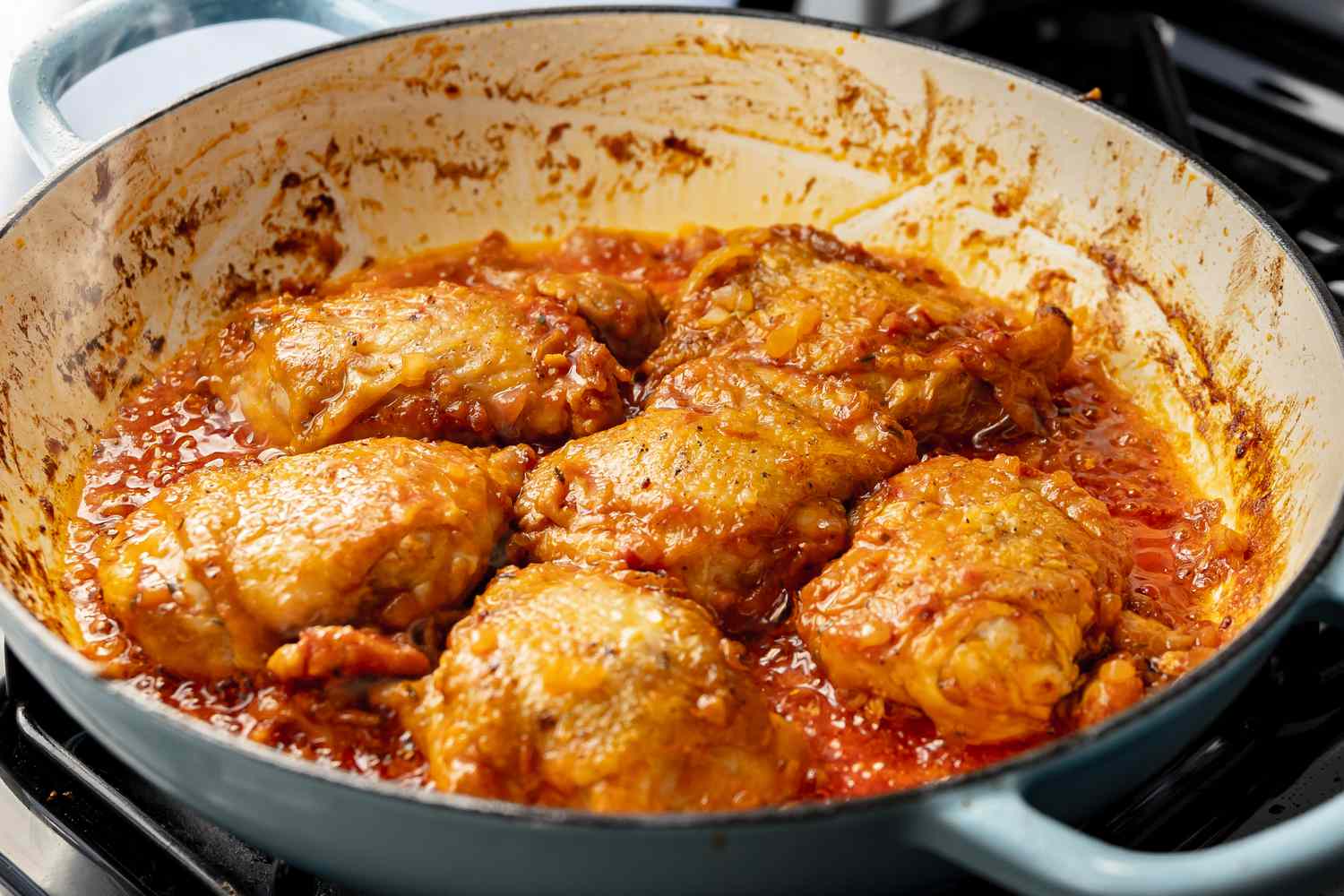 Sauce Ingredients Added to Chicken in a Dutch Oven for One-Pan Spaghetti Recipe 