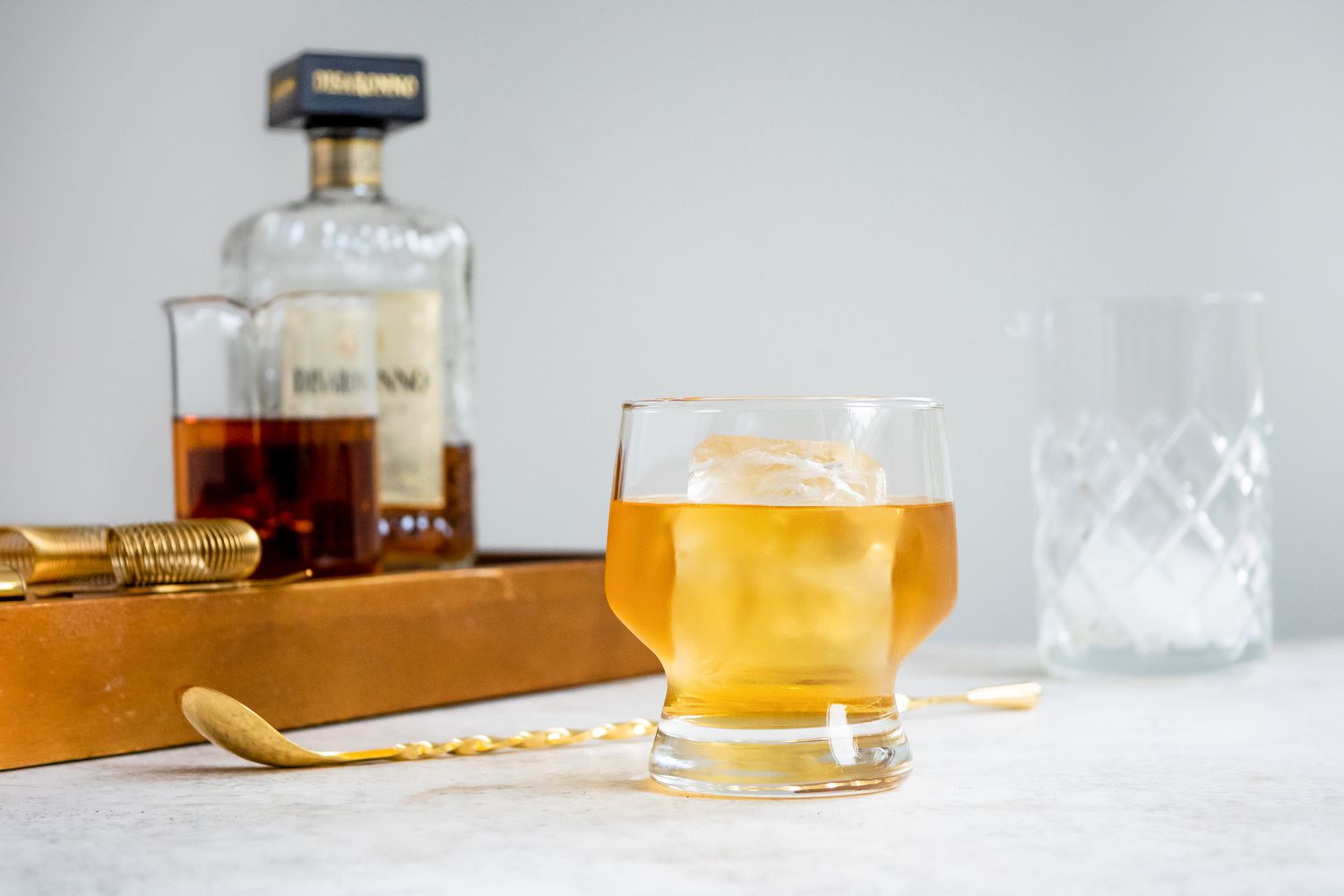 Godfather Cocktail with Ingredients in the Background