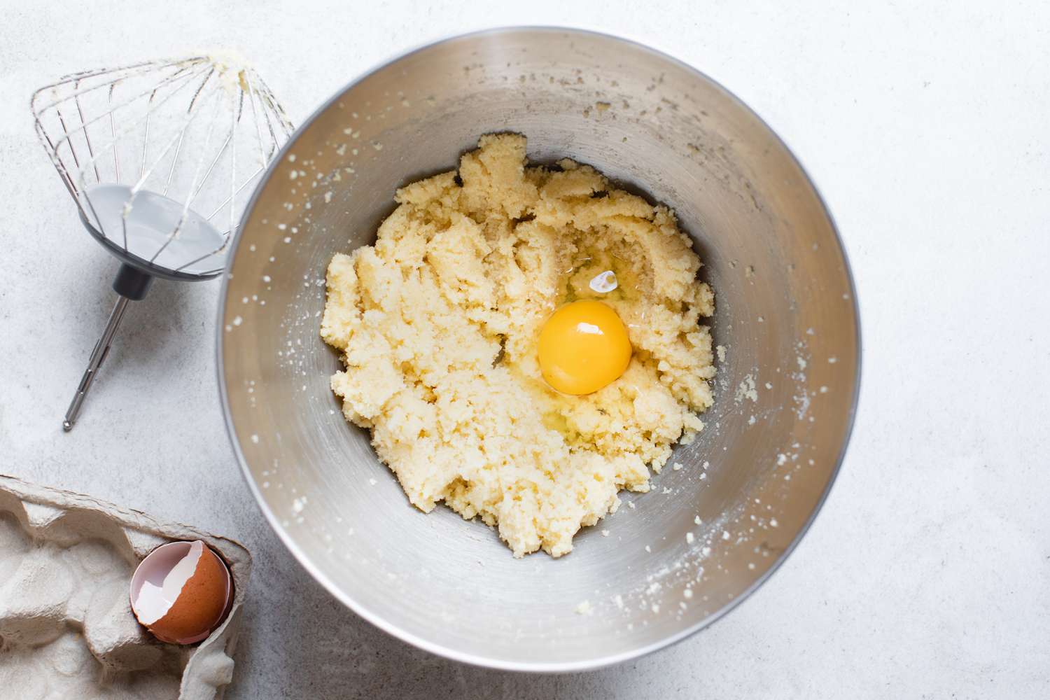 Egg Added to Mixer Bowl with Whisked Sugar and Butter Mixture for Banana Sheet Cake Recipe
