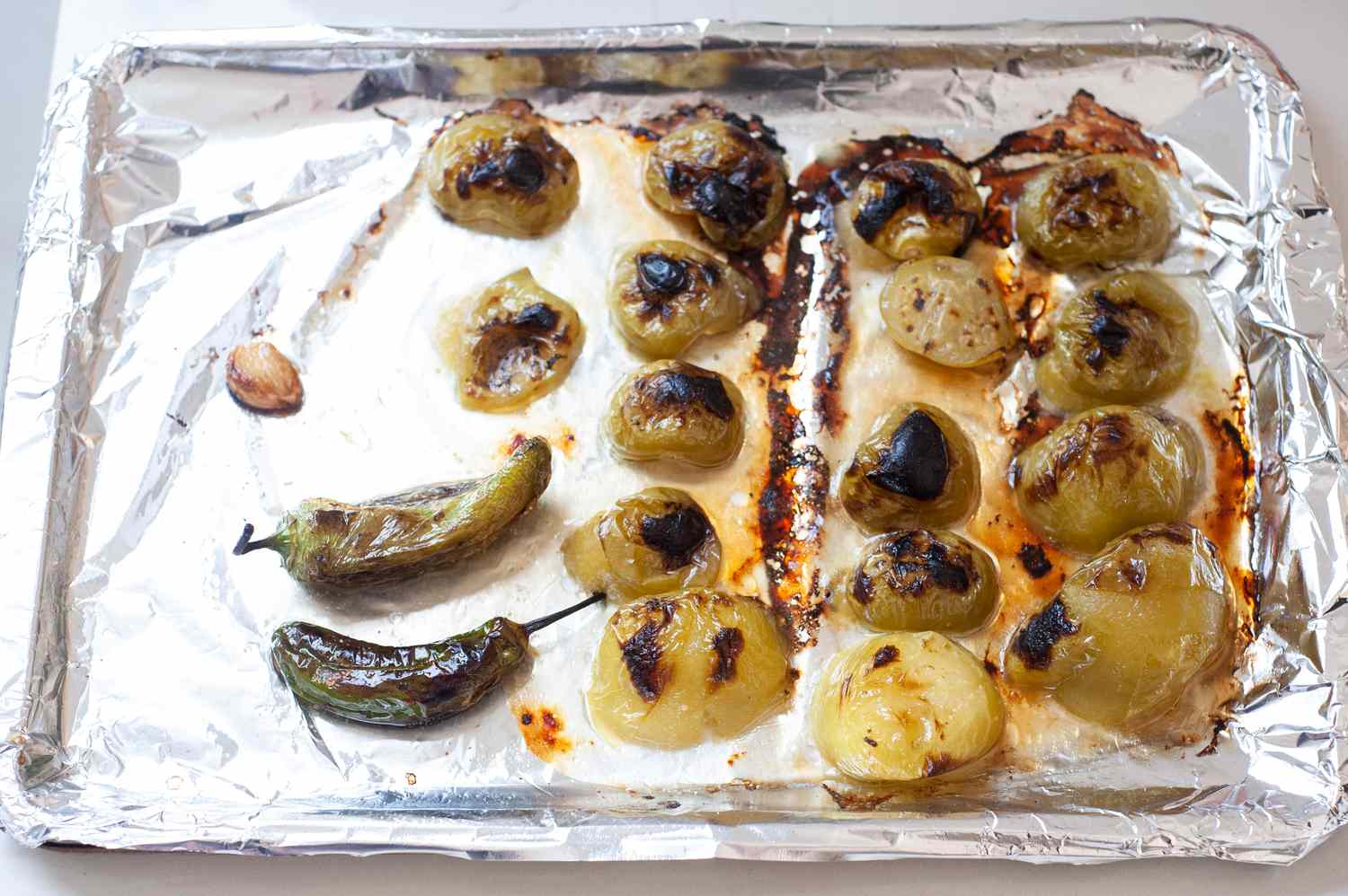 Tomatillos and Jalapeños on Baking Sheet Covered in Foil for Salsa Recipe