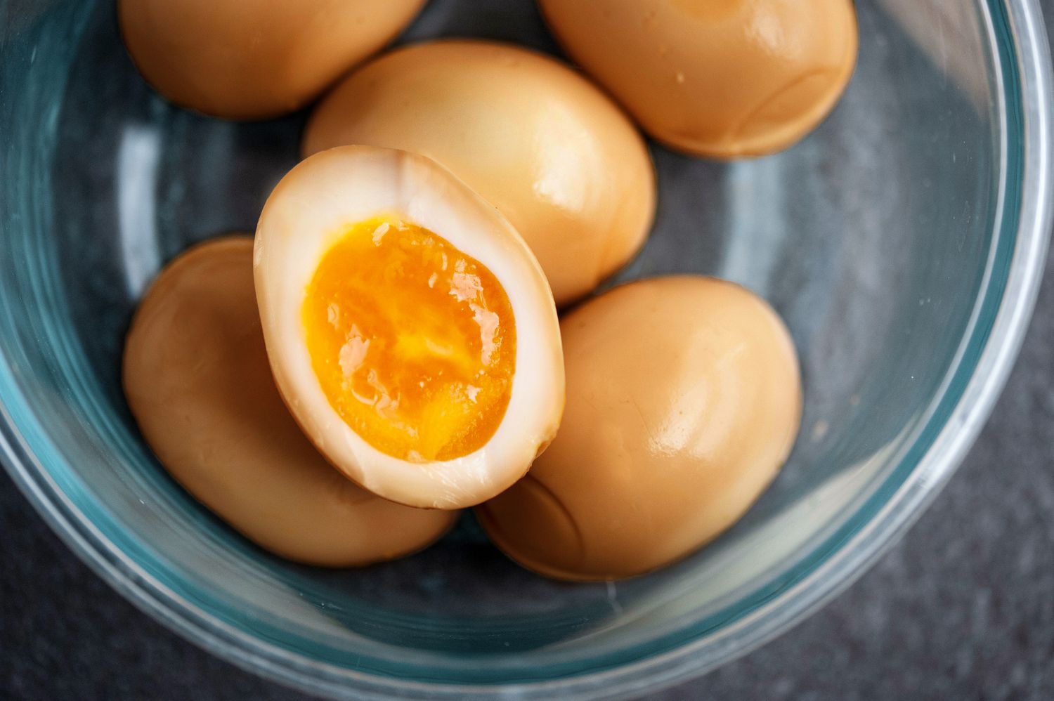 Soy Sauce Eggs in Bowl with an Egg Cut in Half