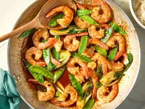 Shrimp Stir Fry in a wok with a wooden spoon