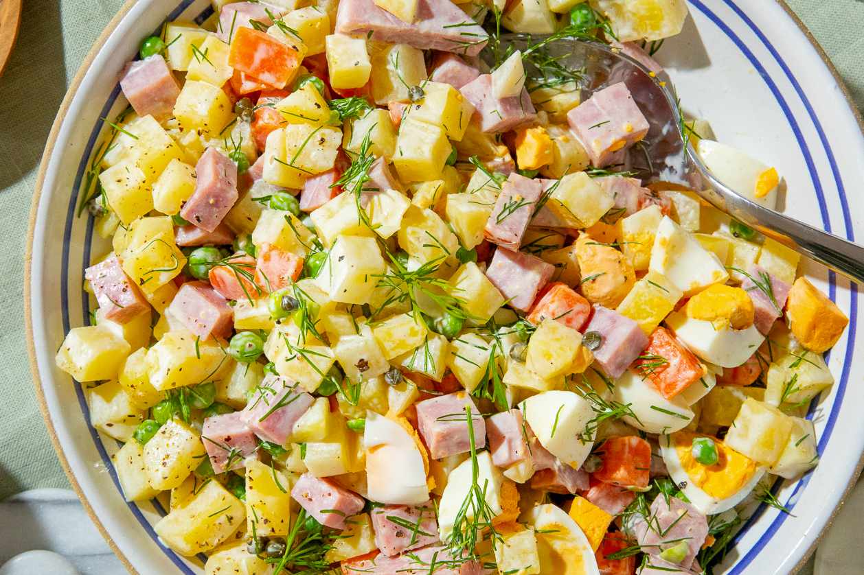bowl of olivier potato salad on a table