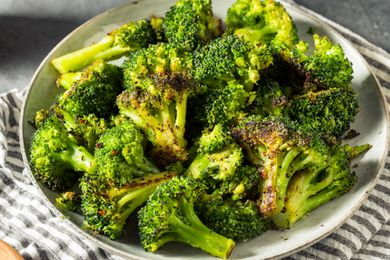 A plate of cooked broccoli seasoned with spices