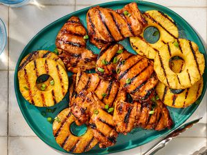 Grilled chicken and pineapple slices on a platter