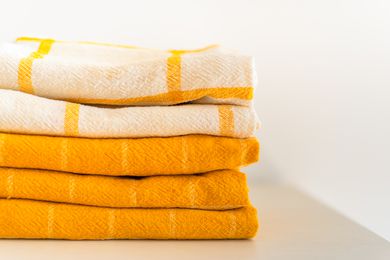 Yellow kitchen towels folded in a neat stack
