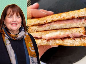 Ina Garten in the foreground, a hand holding a sandwich in the background