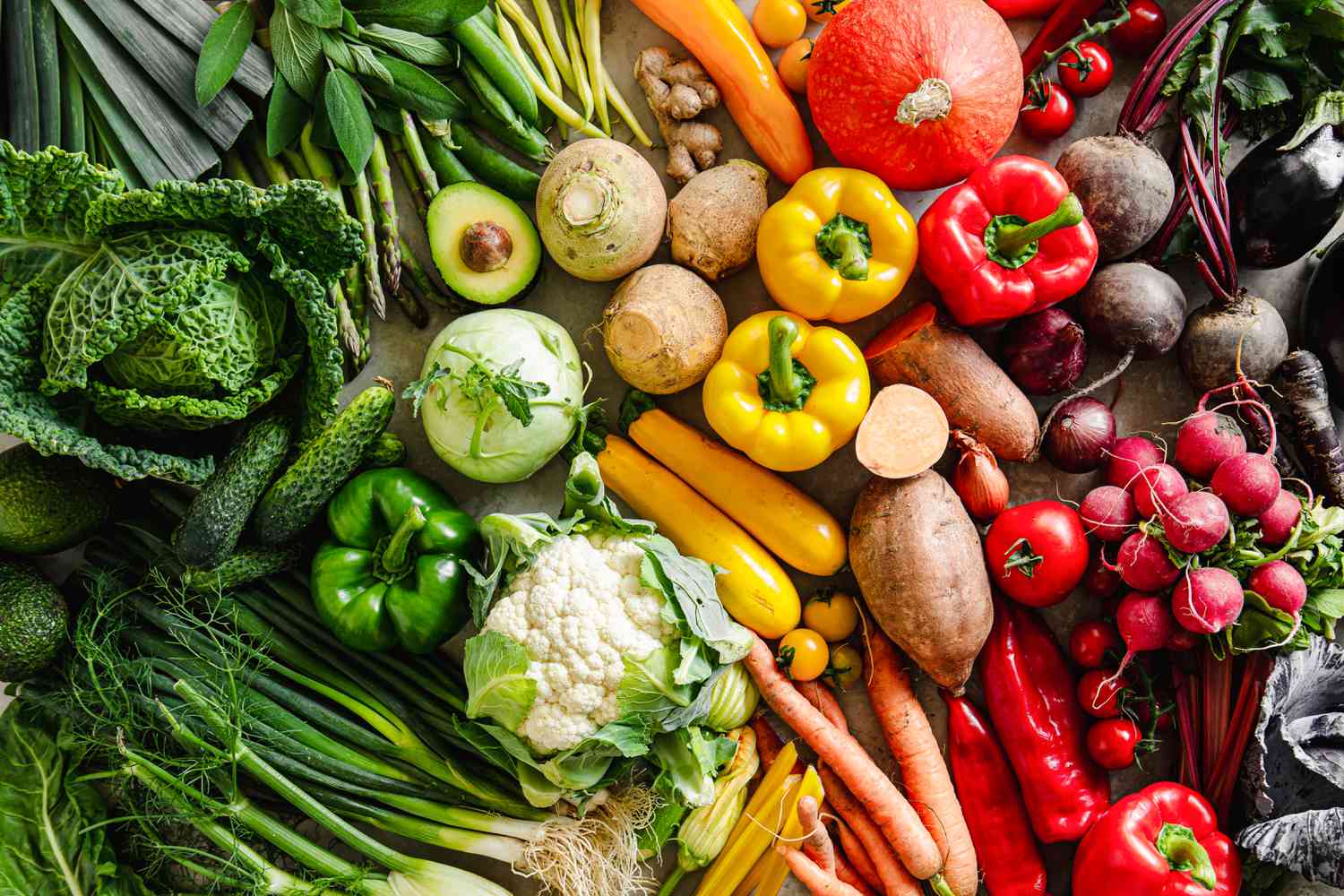 Assortment of various types of vegetables arranged in a rainbow gradient pattern