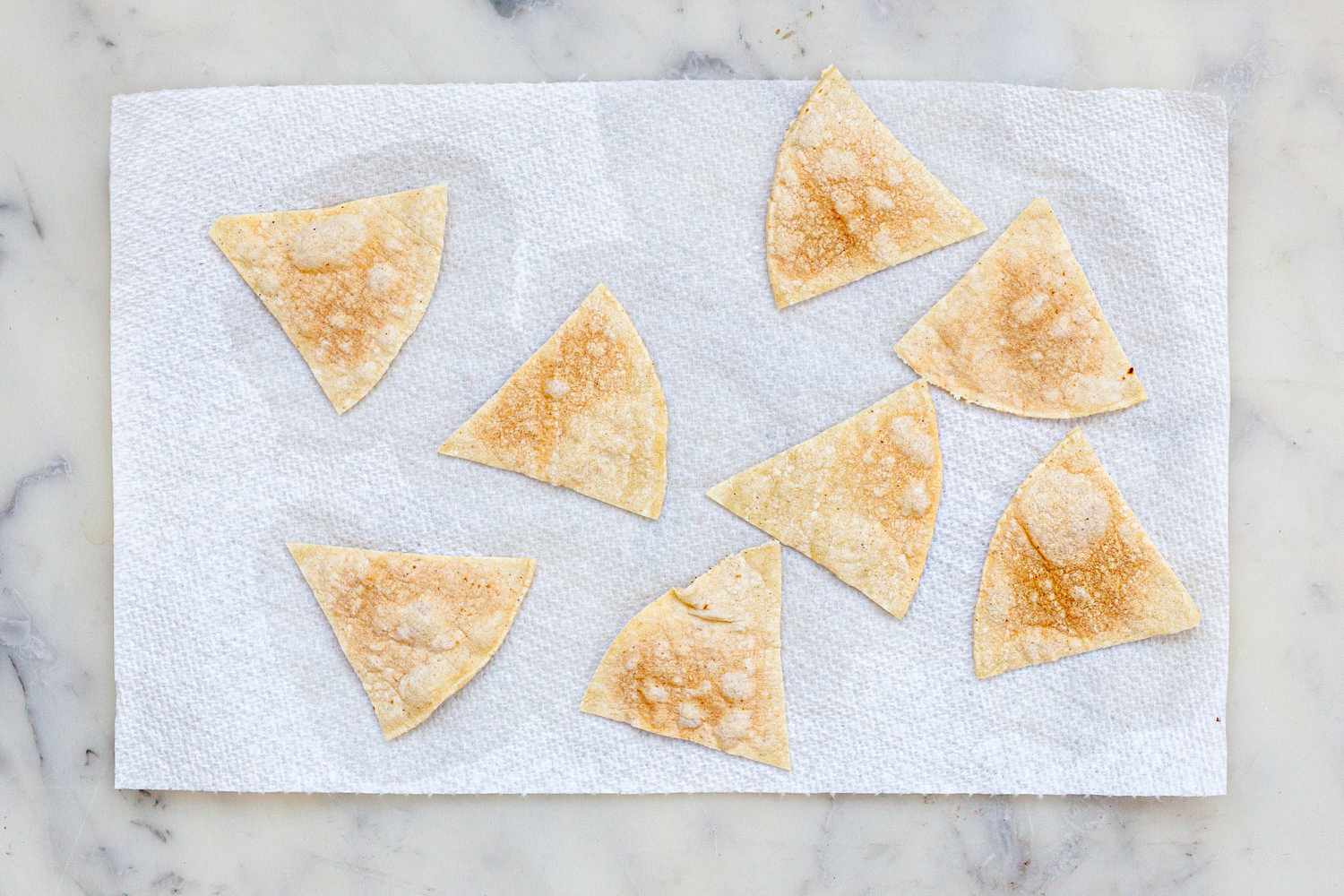 Crispy corn chips on paper towels.