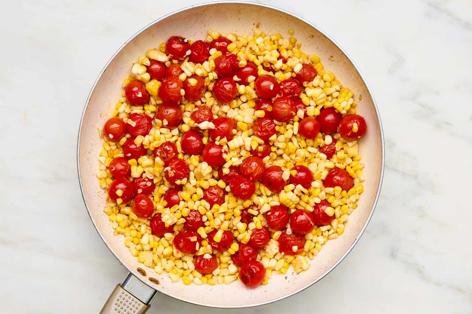 Corn kernels added to skillet with tomatoes for Shrimp with Corn, Pancetta, and Tomatoes stir-fry recipe