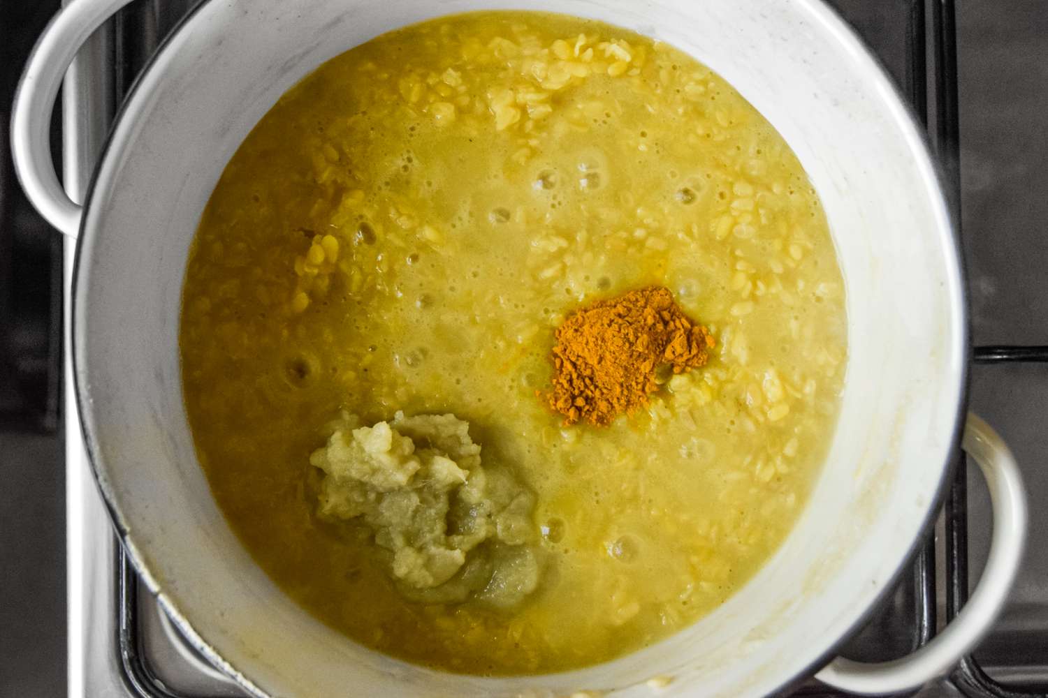 Ginger Paste and Turmeric Added to Dutch Oven for Daal Palak (Lentils and Spinach Curry) Recipe