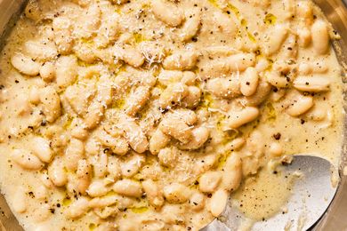 Cacio e pepe white beans with grated cheese on top