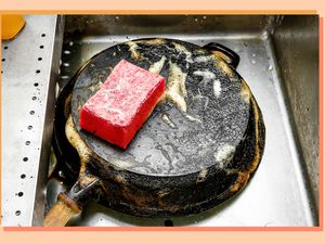 skillet in sink with sponge
