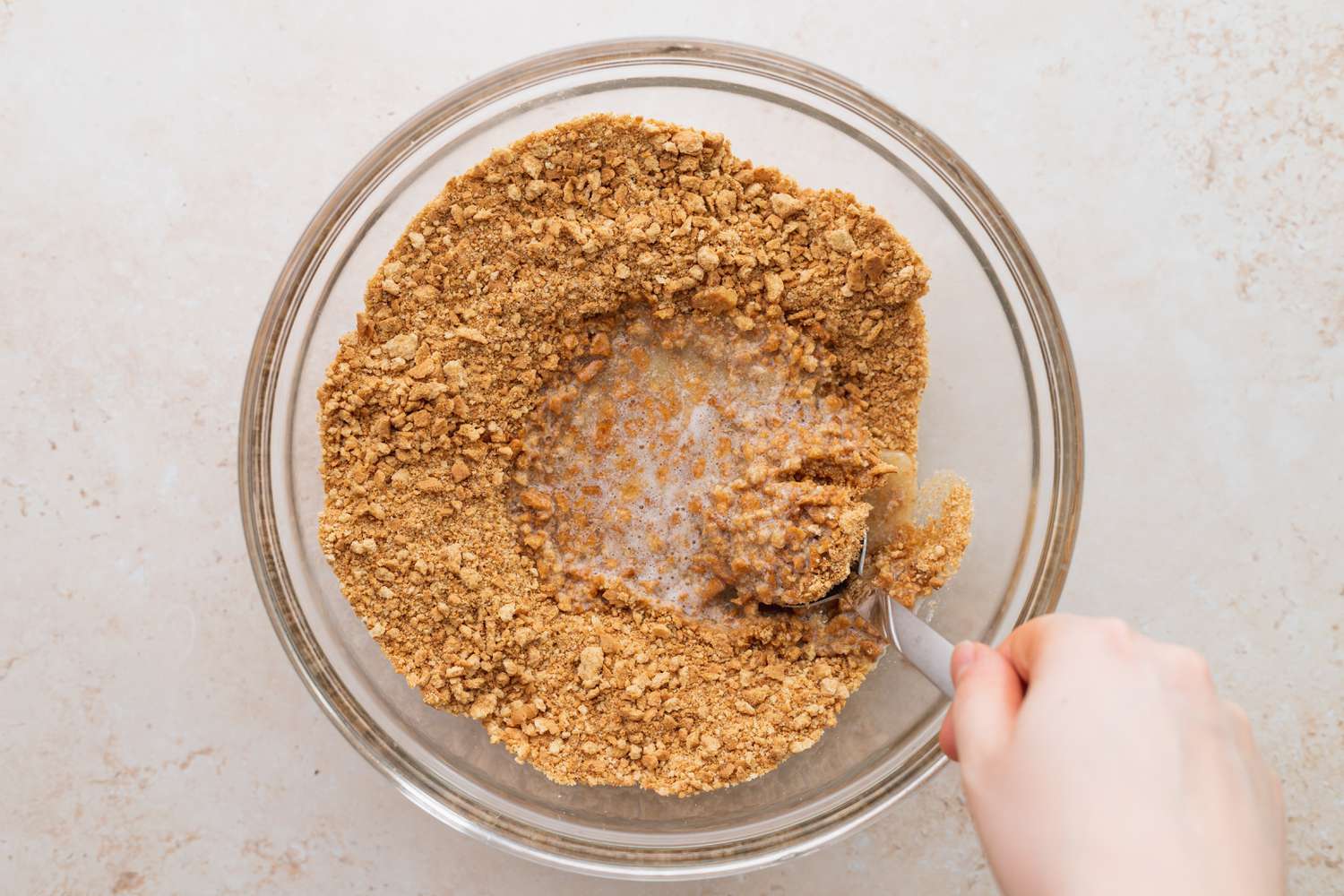 Combine graham cracker with butter.