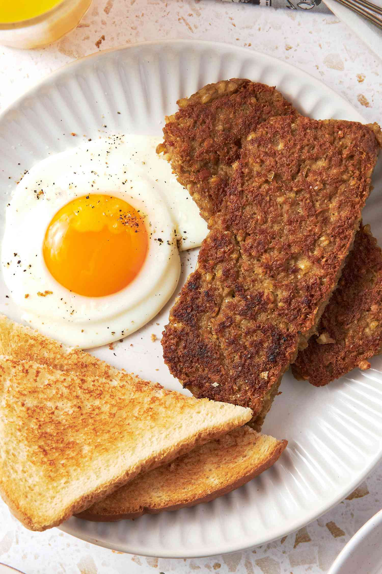 Plate of Sliced Goetta, Sunny Side Egg, and Toast