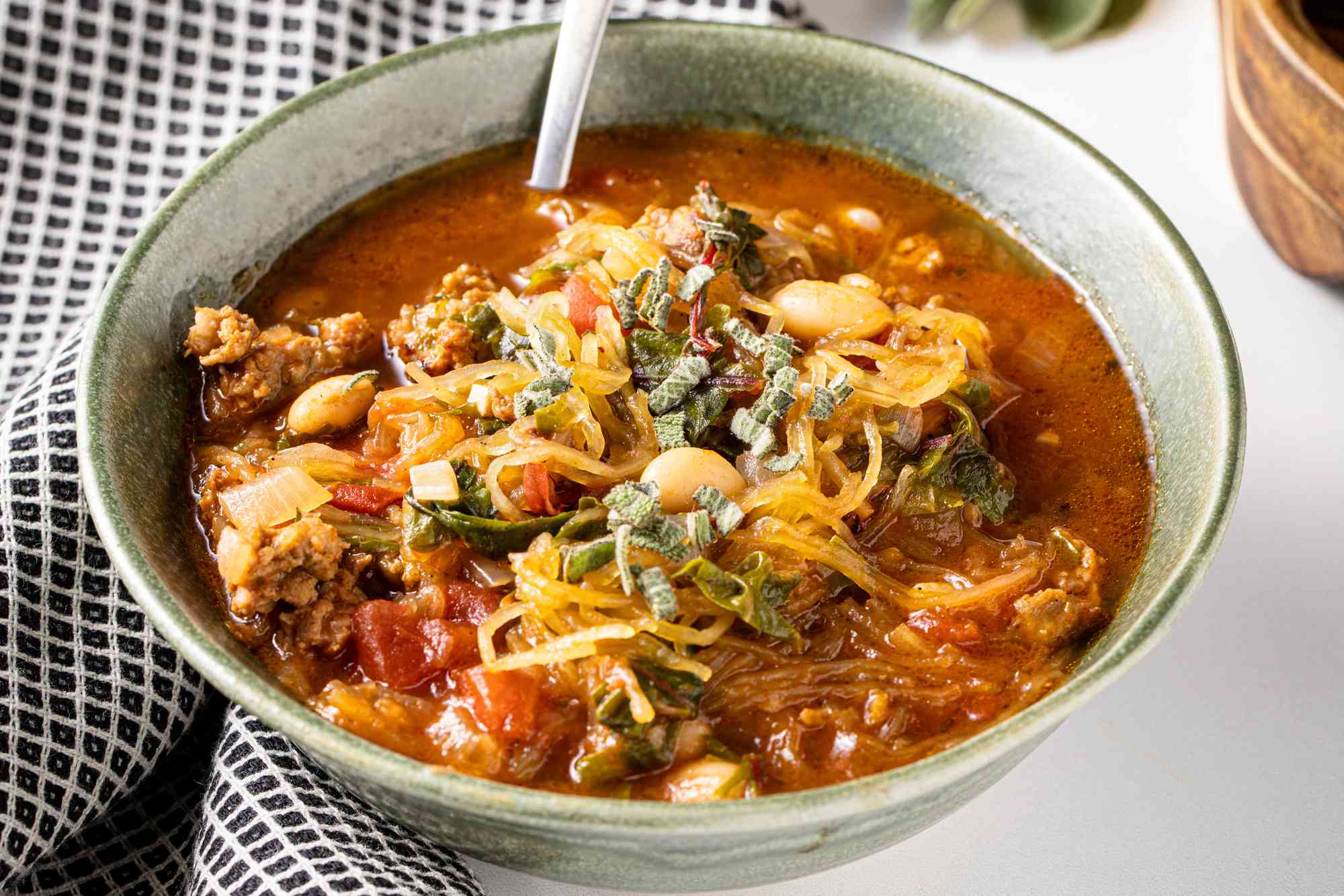 Spaghetti Squash Soup with Italian Sausage Next to a Kitchen Towel