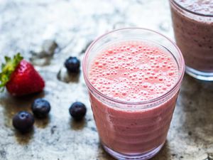 Banana Smoothie with berries on countertop
