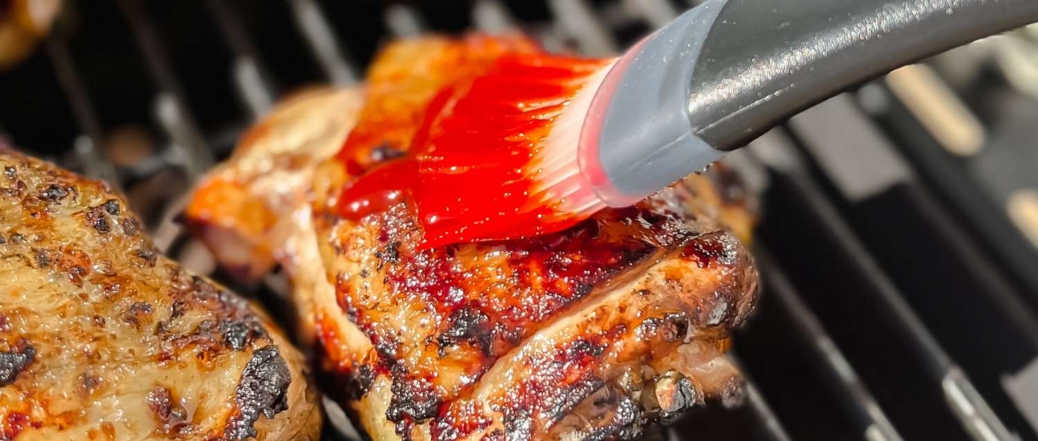 Grilled chicken with paste being brushed on