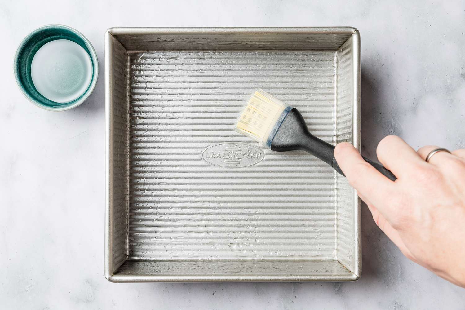 coconut oil used to grease a baking pan for biko (Filipino sticky rice cake) recipe