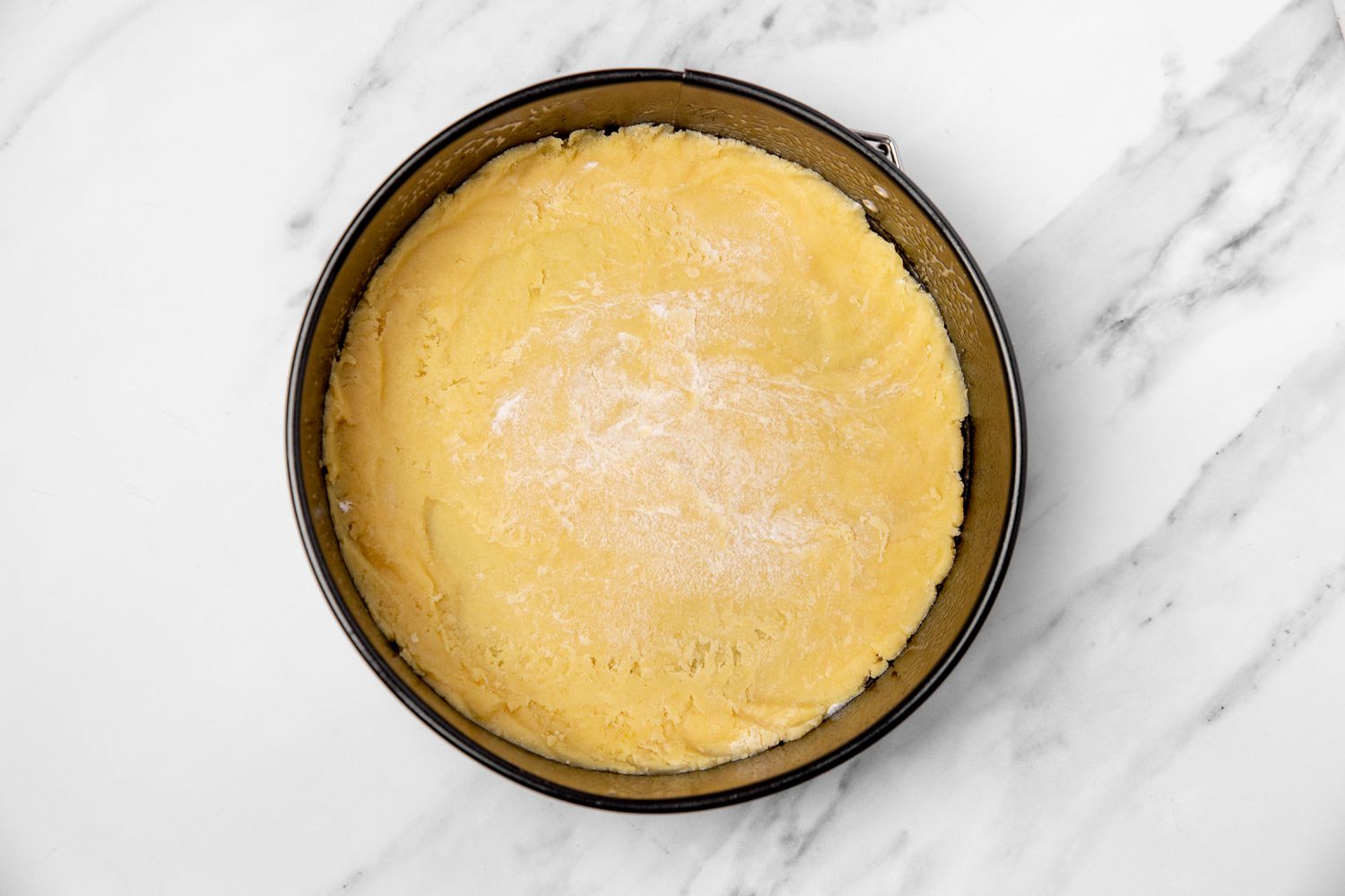 tart dough in a springform pan for german plum tart recipe