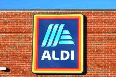 A building with the ALDI logo and sign displayed prominently on a brick wall