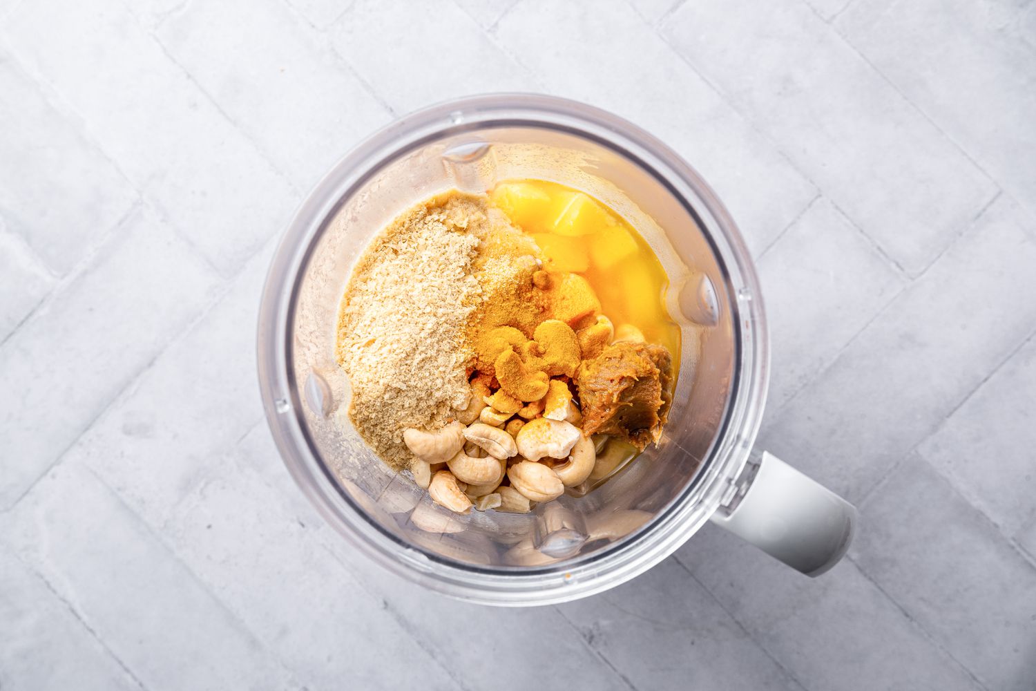 Cashews, Nutritional Yeast, Boiled Vegetables, and Miso Added to a Blender for Vegan Macaroni and Cheese Recipe