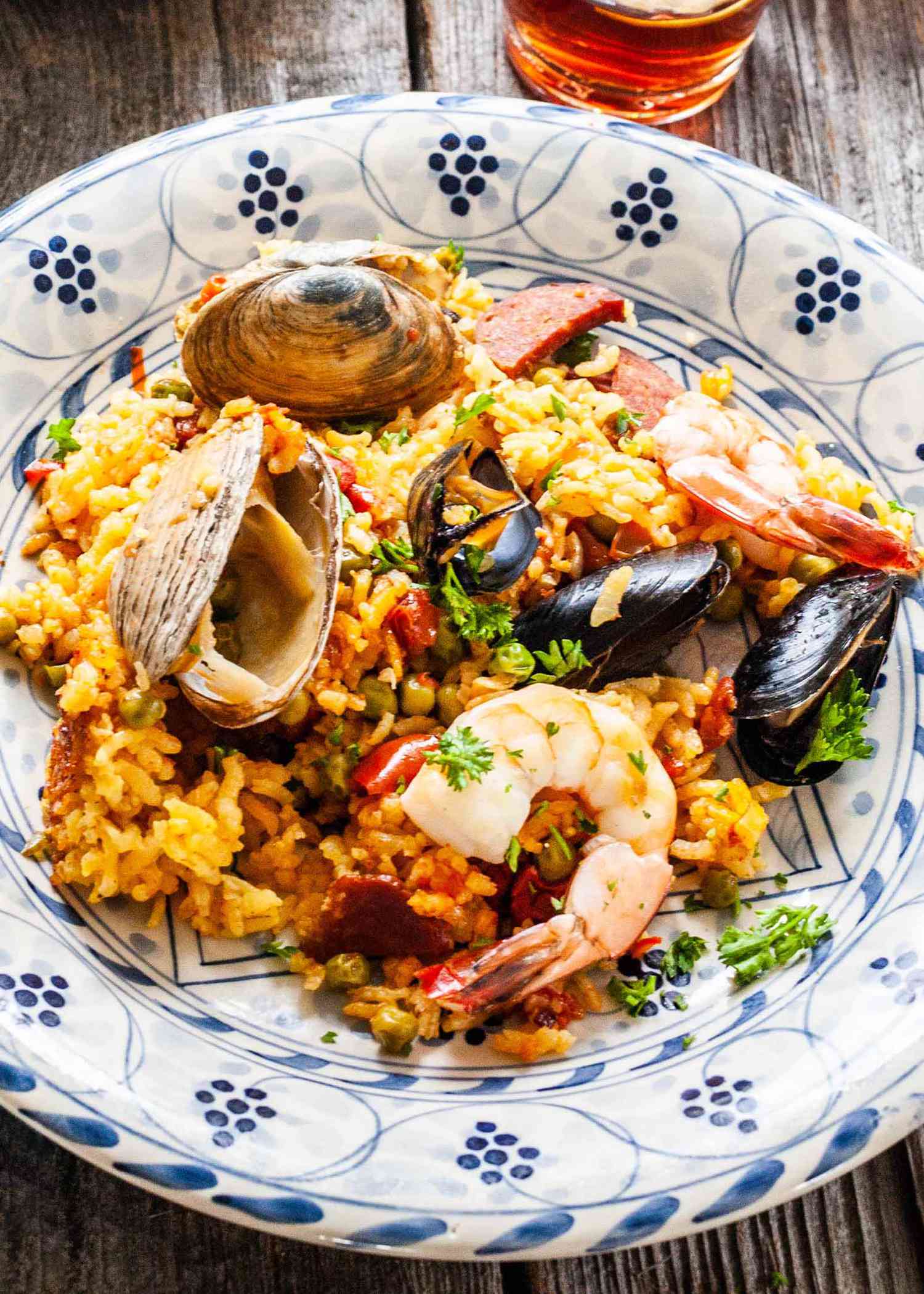 Seafood paella on a blue and white plate