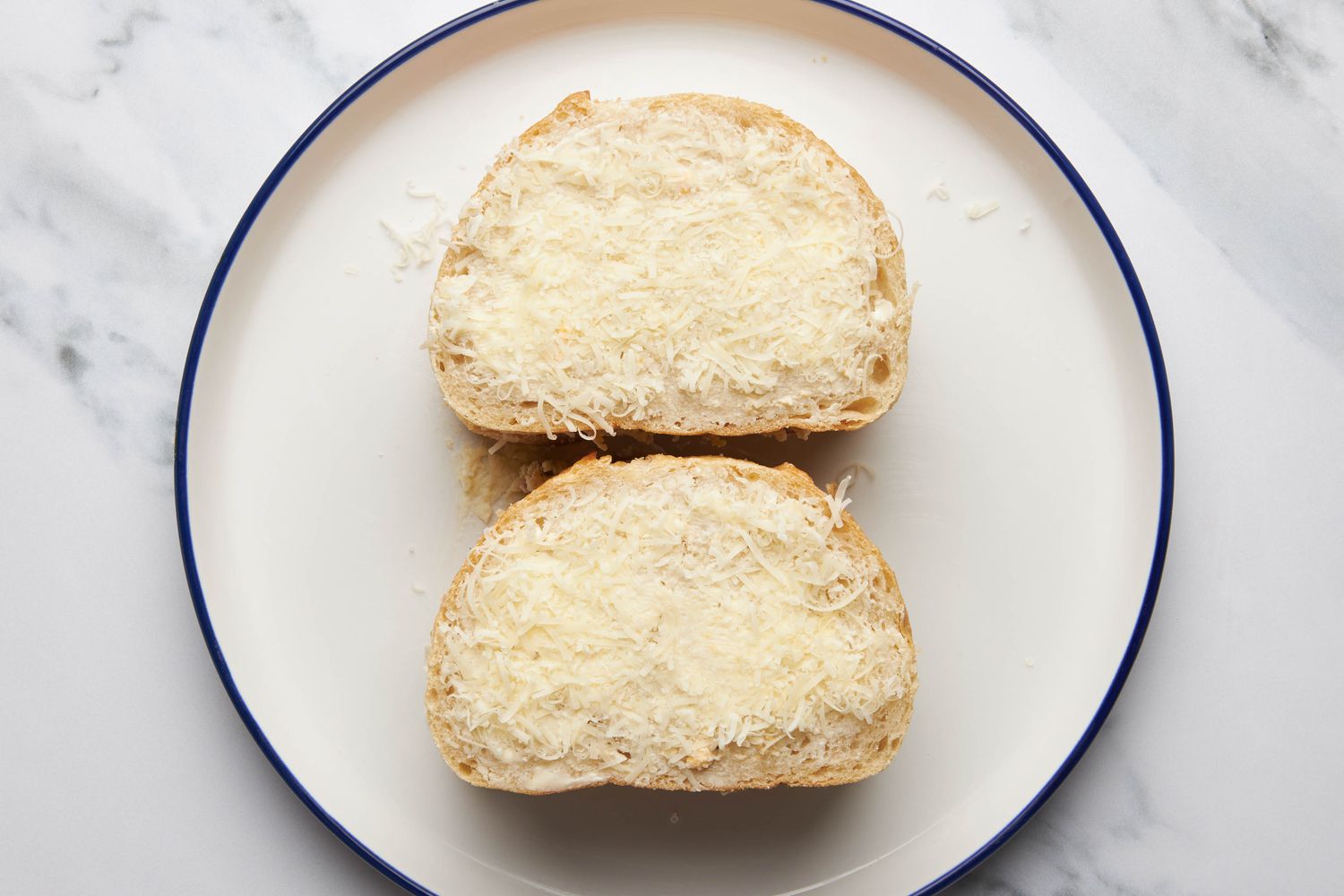 Assemble the sandwich: remaining two slices stacked onto the filling and topped with grated parmesan