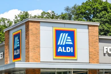 The exterior of an Aldi store with the Aldi logo visible on the building