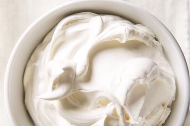 A bowl of whipped cream with a smooth texture